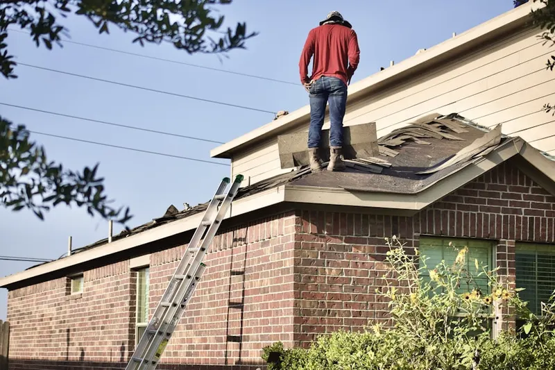 Professional roofer working on a residential roof in Goose Hollow